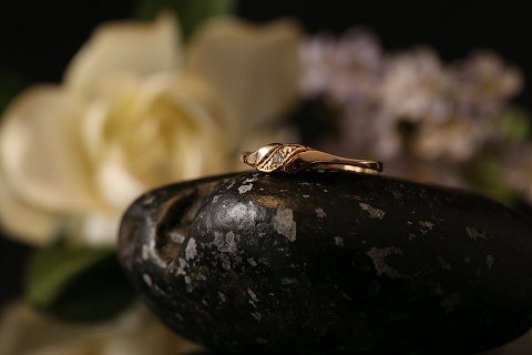 Unique gold ring in 14 carat gold and white zircon. Great design and special 
look. Size 56.