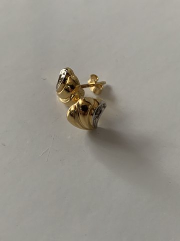 Ørestifter i 14 karat  rød- og hvidguld med indlagt brilliant.