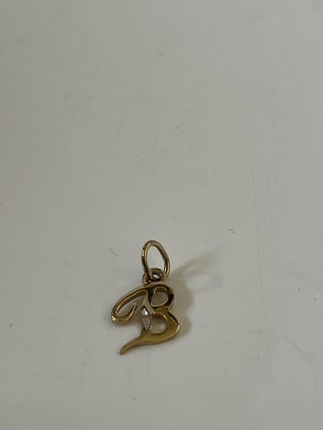 14 carat gold pendant, shaped like the letter B with inlaid diamond