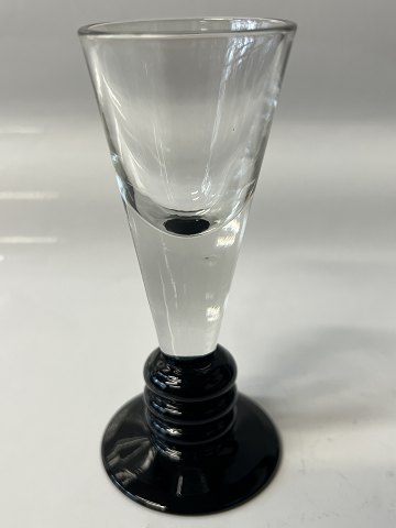 Shot glass on black base,Height: cm. 10.7 cm.Designed by Jacob E Bang Holmegaard.