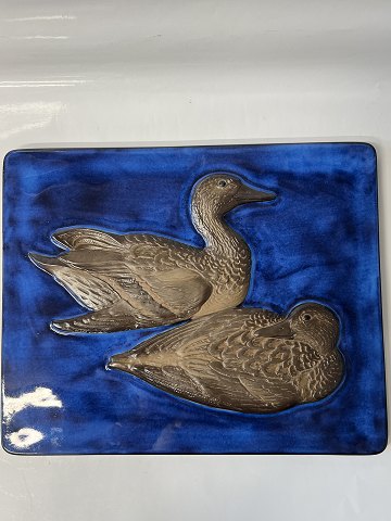 Relief of ceramics with a motif of ducks on a blue background.560/2903