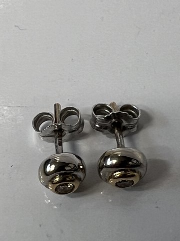 Earrings in 14 carat white gold / red gold, with inlaid diamond.