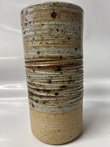 Ceramic vase cylindrical with horizontal, incised grooves. Height 21 cm.