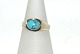 Gold ring with light blue stones