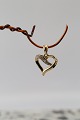 Heart-shaped pendant in 14 carat gold, with diamonds. Stamped 585 BEE. Very 
exclusive.