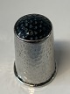Silver finger ring with black flounce.
