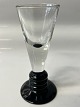 Shot glass on black base,Height: cm. 10.7 cm.Designed by Jacob E Bang Holmegaard.