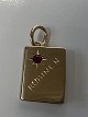 14 karat guld. Bog med indlagt rød rubin.Charms / Vedhæng.Højde 1,9 cm.